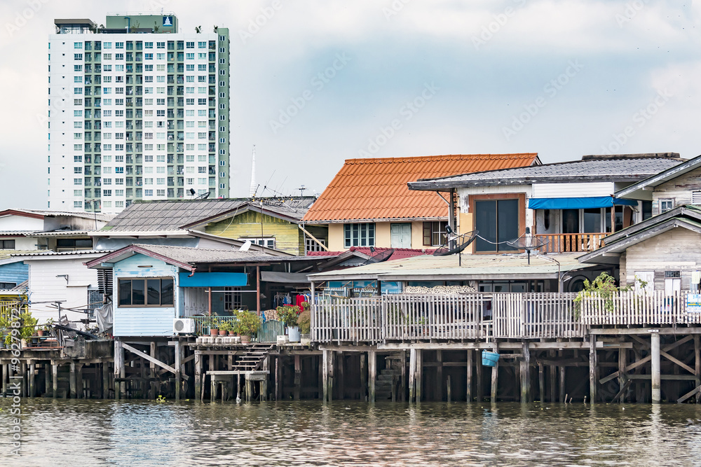 houses on stilts along the river in Bangkok