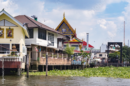 houses on stilts along the river in Bangkok