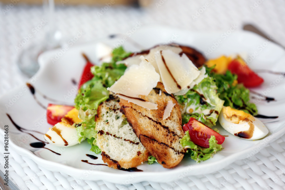 Tasty salad on white served table, outdoors Tasty salad on white served table, outdoors