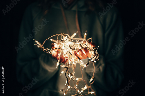 woman holding electric garland