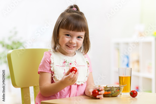 child girl eats dinner and ...