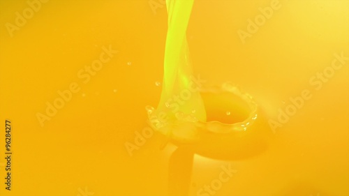 Pouring orange juice shooting with high speed camera.