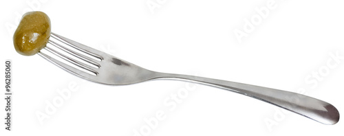 fork with impaled green olive isolated