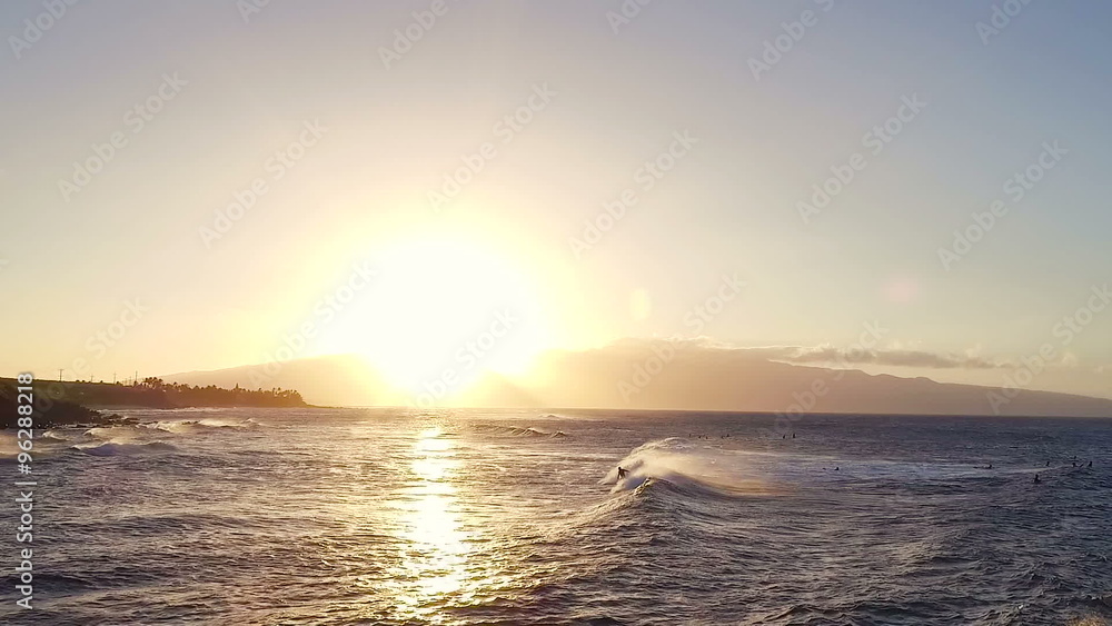 AERIAL Flight Over Surfers Surfing Ocean Waves at Sunset. Amazing Sunset Aerial Shot Flying Low Over Ocean AERIAL Flight Over Surfers Surfing Ocean Waves at Sunset. Amazing Sunset Aerial Shot Flying Low Over Ocean