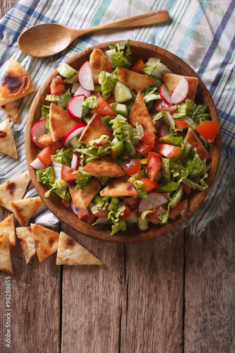 Traditional Arabic fattoush salad on a plate. vertical top view
