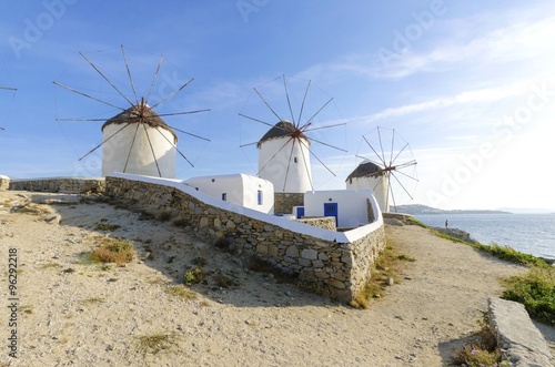 Three windmills in Chora,Mykonos,Greece.Traditional greek whitewashed architecture,a popular landmark,tourist destination on the island of winds,deep blue sky,Aegean sea. Wind mills are now decorative