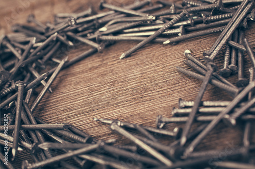 iron nails on wooden background