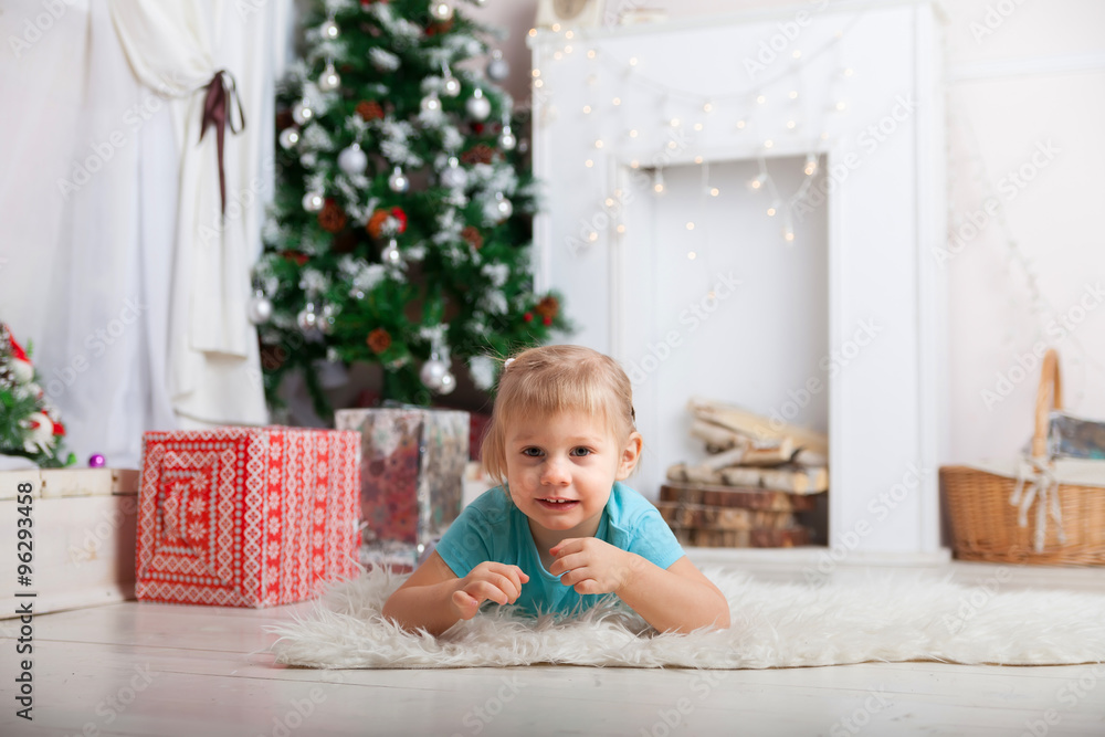 Little blond baby at New Year's Tree Little blond baby at New Year's Tree