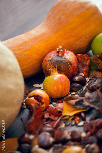 A table of autumn fruits. The fruits of autumn. Pumpkins, pomegranates, chestnuts, apples