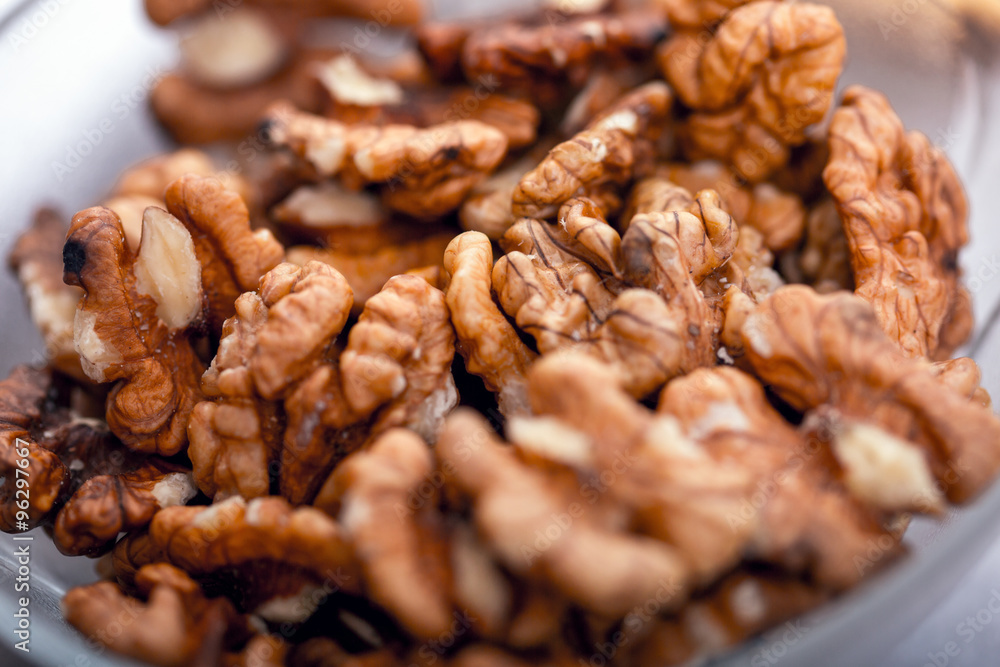 Heap of raw walnuts close-up as background. Heap of raw walnuts close-up as background.