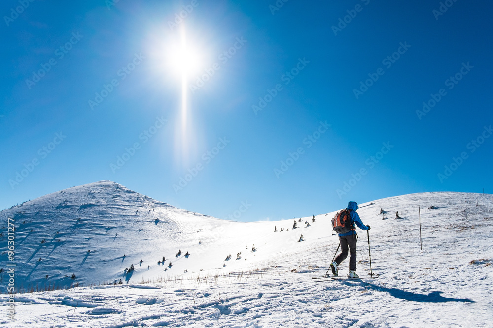 skialpinist on snowy mountains