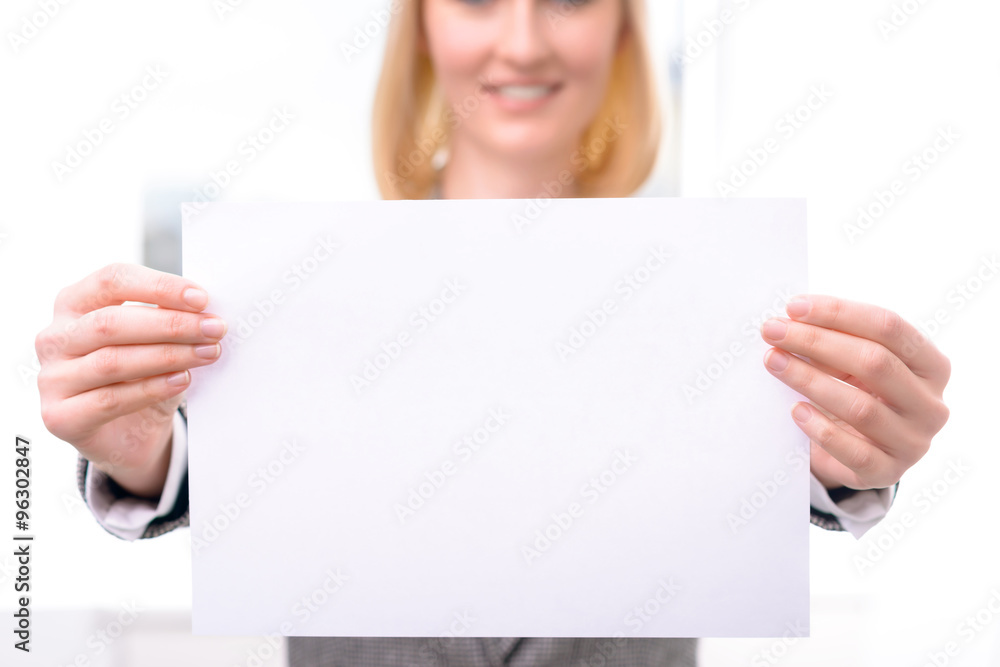 Professional businesswoman holding sheet of paper Professional businesswoman holding sheet of paper