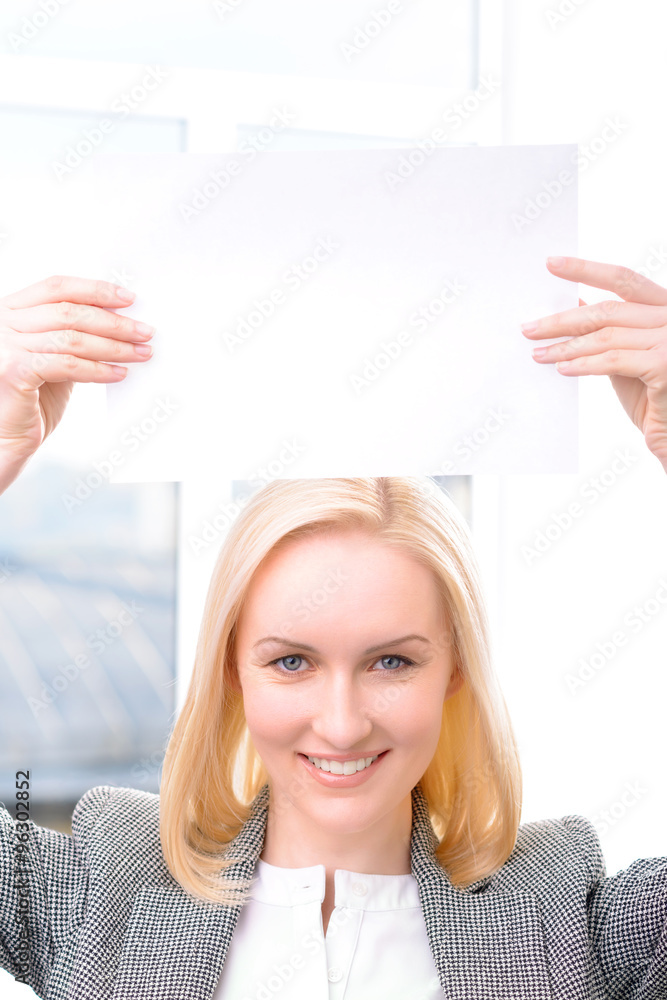 Professional businesswoman holding sheet of paper Professional businesswoman holding sheet of paper