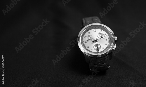 Men's watch with leather strap on dark background
