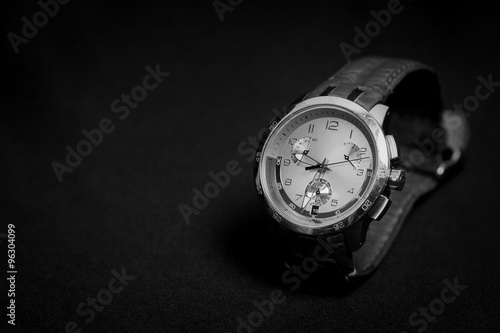 Man watches on black background, closeup