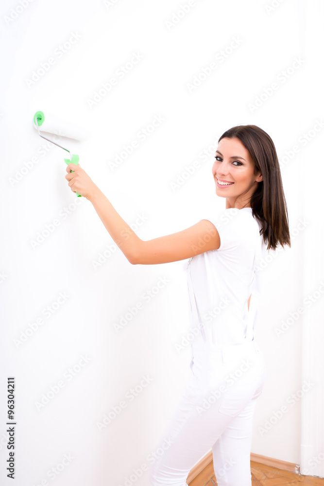 Beautiful young woman painting a Apartment Beautiful young woman painting a Apartment
