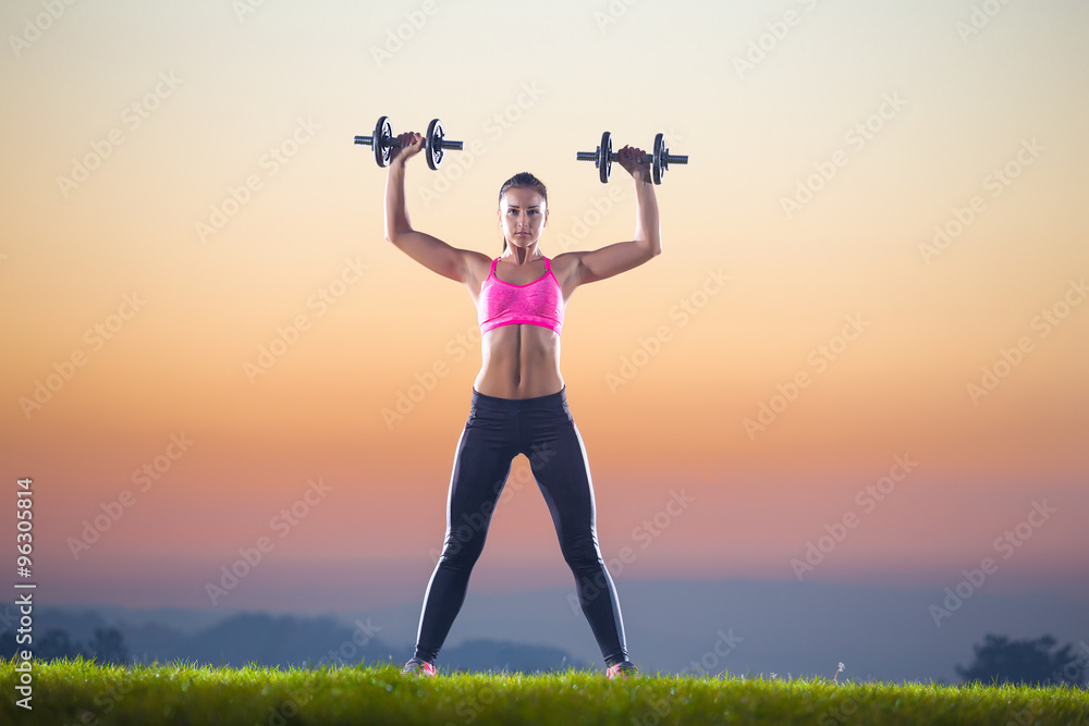 pretty girl with hand weight outdoor on sunset pretty girl with hand weight outdoor on sunset