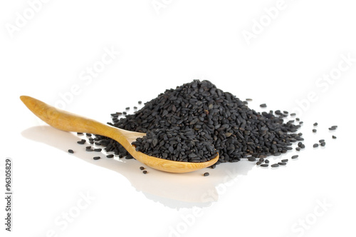 Heap of black sesame on wooden spoon