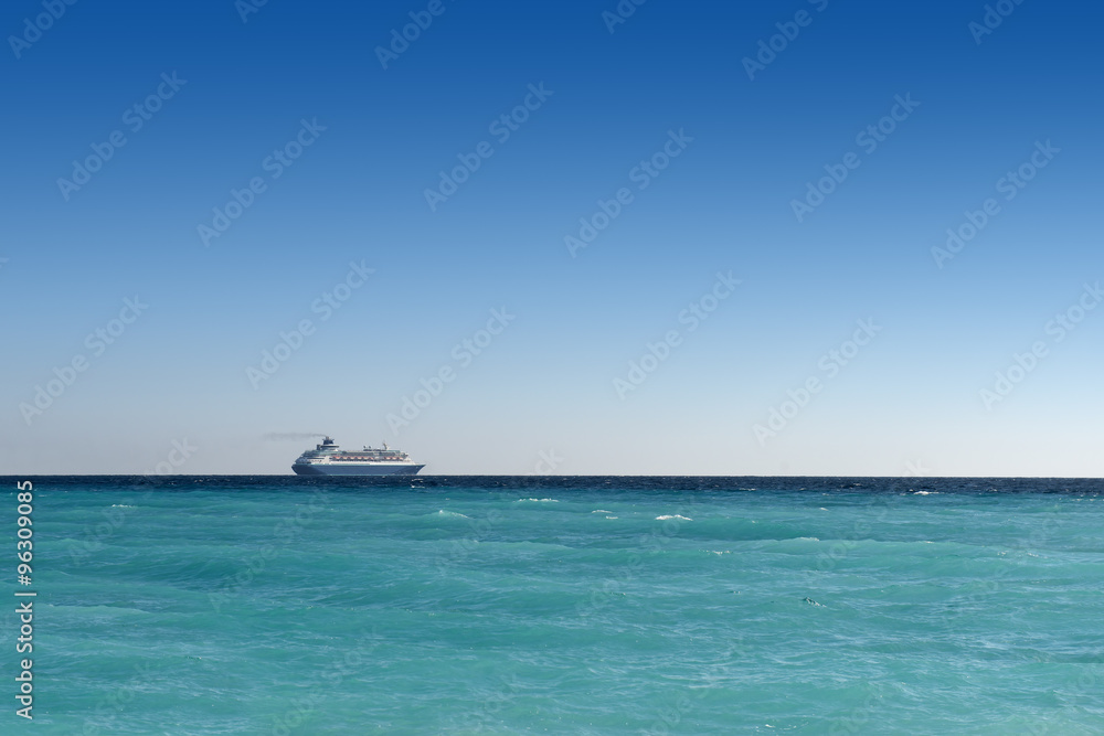 cruise liner sailing away on turquoise water and blue sky backround cruise liner sailing away on turquoise water and blue sky backround