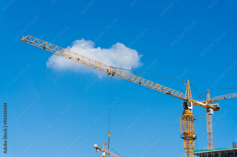 Construction site with cranes against blue sky. Bangkok, Thailan