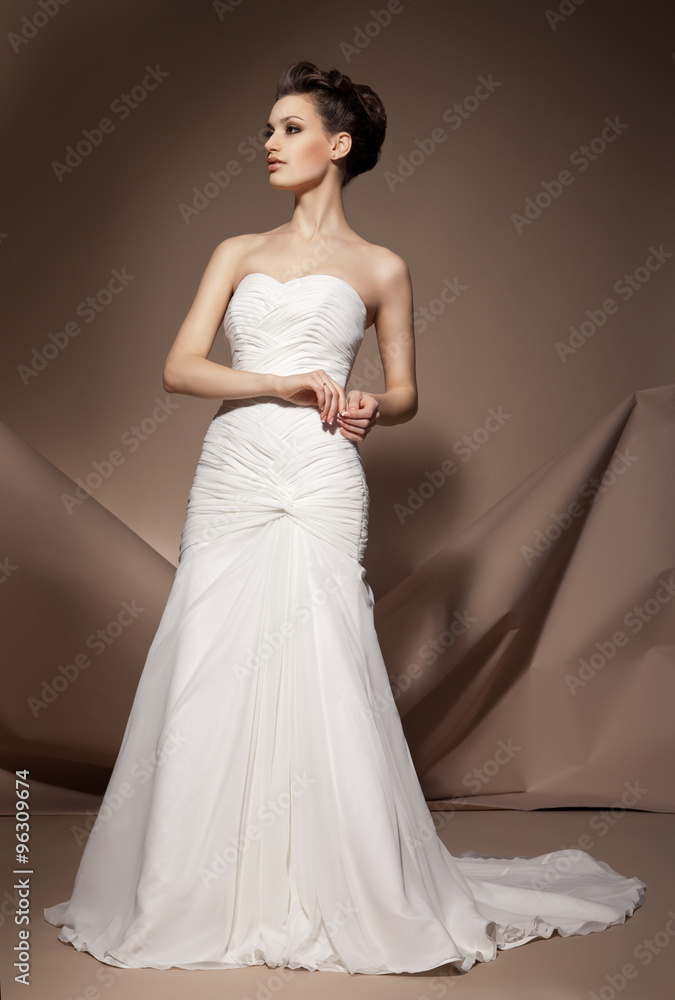 The beautiful young woman in a wedding dress
