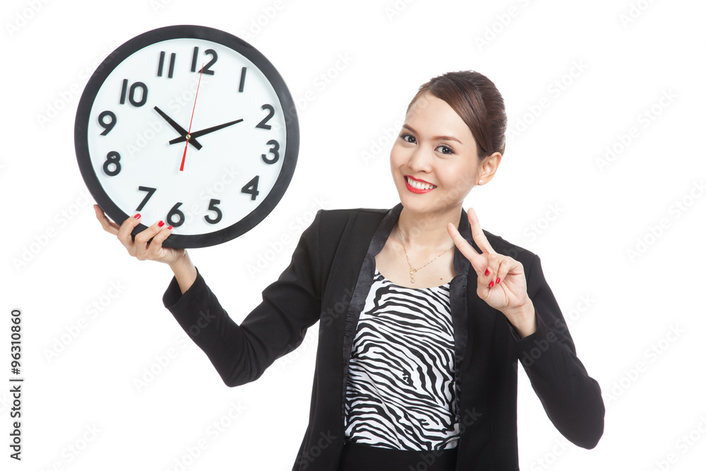 Young Asian business woman show victory sign with a clock Young Asian business woman show victory sign with a clock