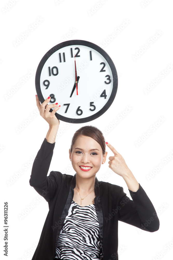 Young Asian business woman point to a clock Young Asian business woman point to a clock