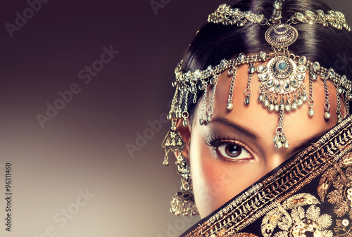 Beautiful Indian women portrait with jewelry. elegant Indian girl , bollywood style .  Indian jewelry with  dark skin model . Beautiful brunette asian girl with black veil on face  photo