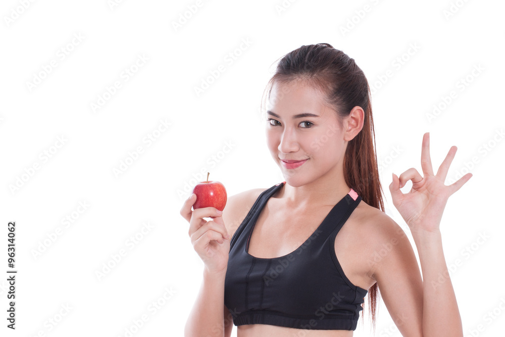 Fitness woman holding apple and showing ok sign. healty concept Fitness woman holding apple and showing ok sign. healty concept