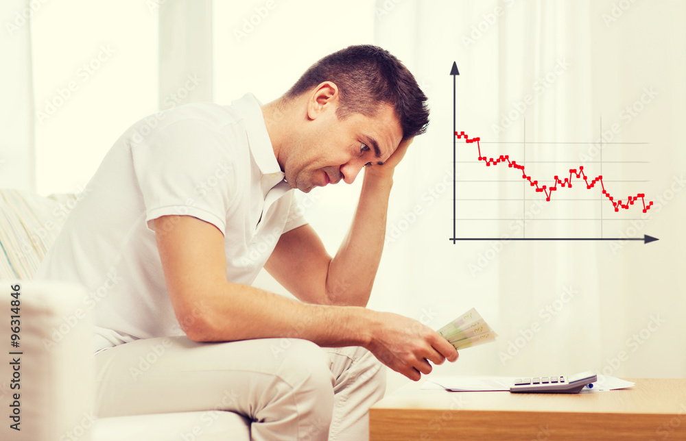 Obraz premium man with money and calculator at home