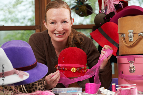 Hat Maker Working On Design In Studio photo