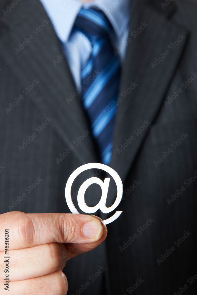 Businessman Holding @ Symbol Businessman Holding @ Symbol