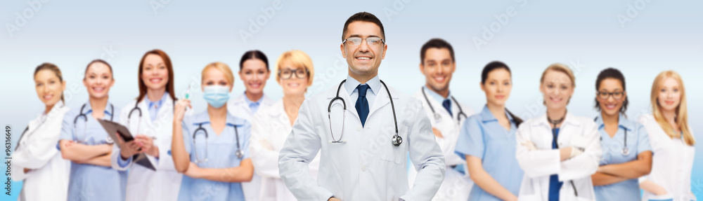 group of smiling doctors with clipboard over gray group of smiling doctors with clipboard over gray