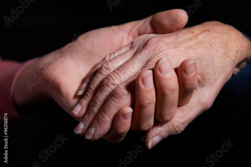 Young Woman Holding Older Woman's Hand