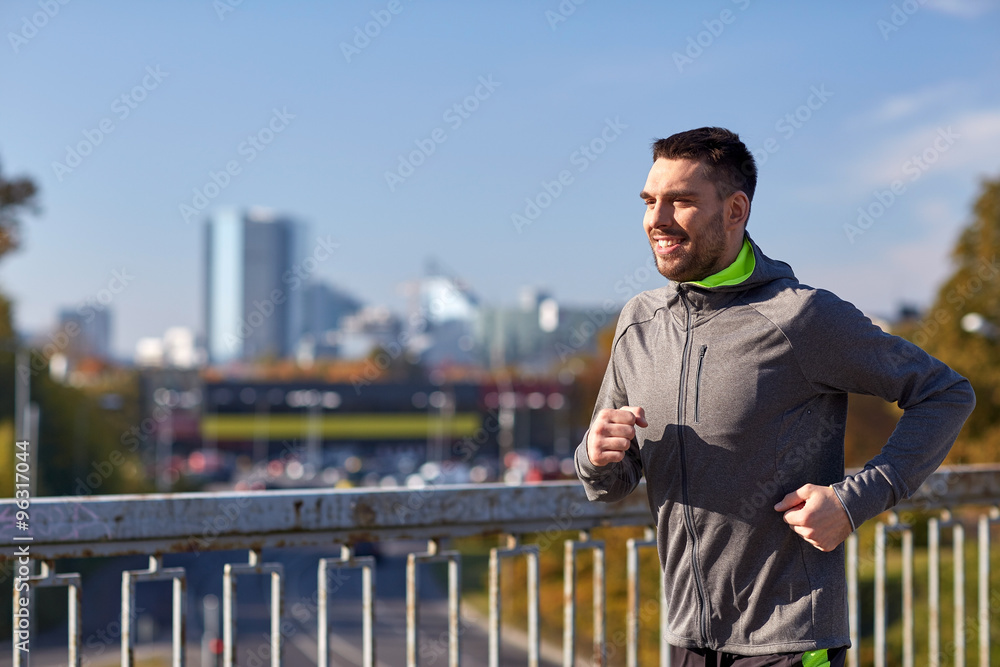 happy young man running over city bridge happy young man running over city bridge