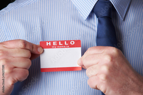 Businessman Attaching Name Tag At Conference