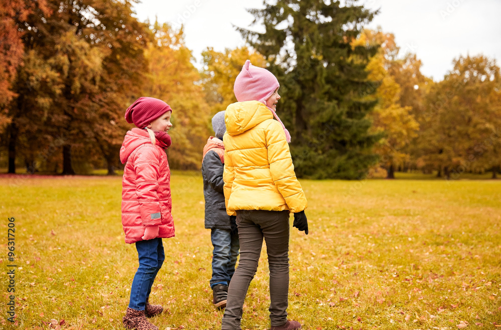 group of happy children in autumn park