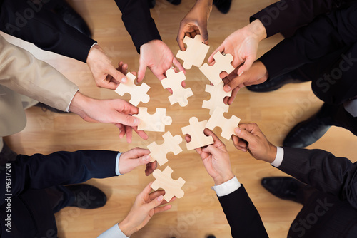 Business Team Joining Jigsaw Pieces