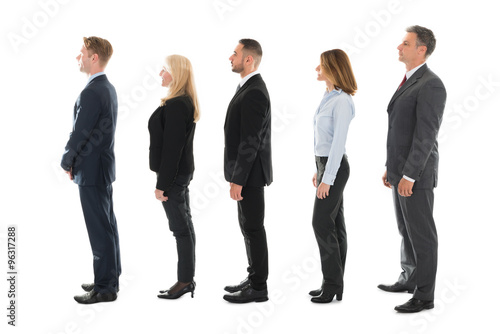 Side View Of Business People Standing In Row