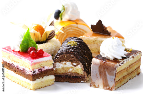 Stampa su tela Assorted different mini cakes with cream, chocolate and berries