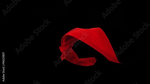 Red fabric flowing in the air on black background shooting with high speed camera, phantom flex.