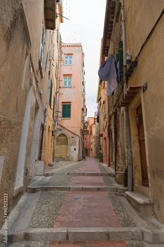 downtown Menton in France, the old narrow streets with colored buildings, windows and doors. Cote d'Azur.