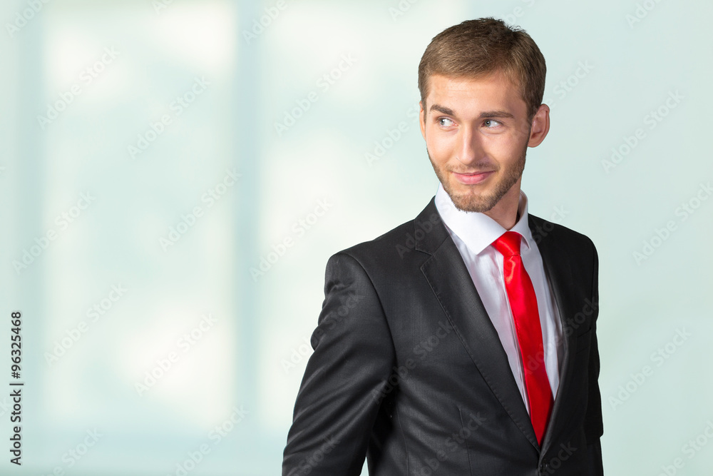 Young Businessman looking over his shoulder Young Businessman looking over his shoulder