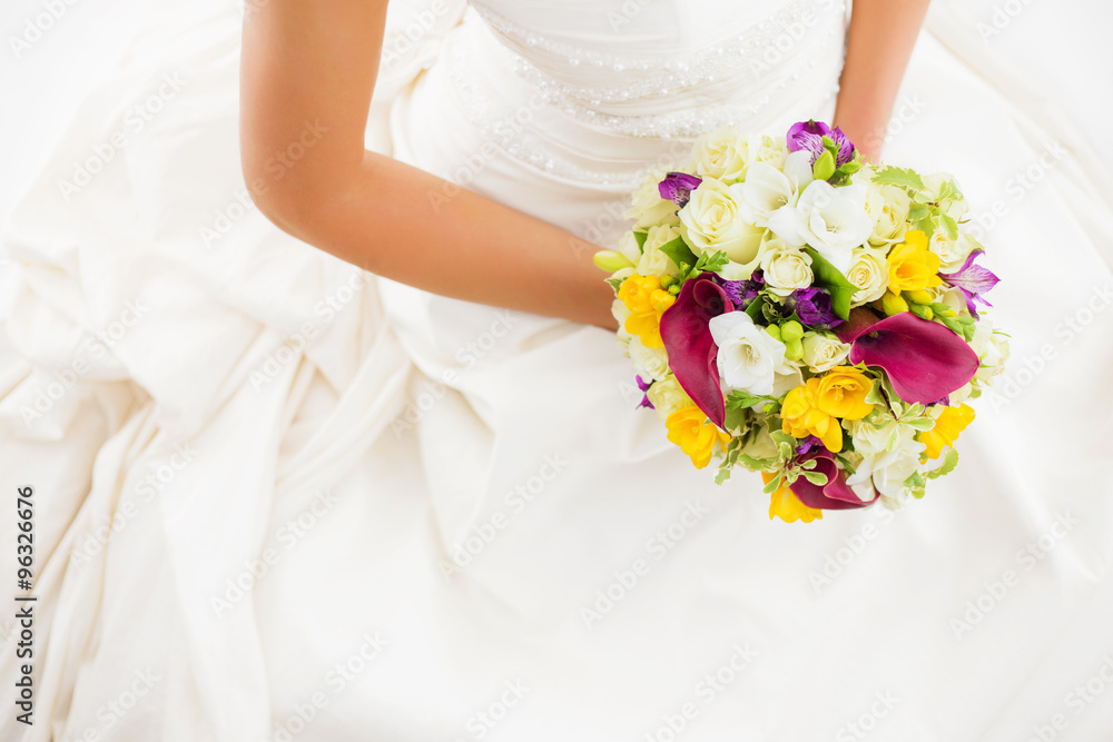 Female in white wedding dress holding flowers Female in white wedding dress holding flowers
