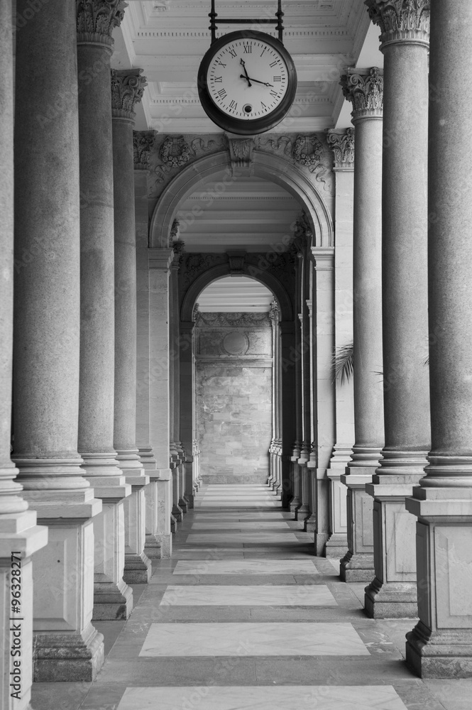 Old clock, and stone columns in Karlovy Vary, Czech Republic Old clock, and stone columns in Karlovy Vary, Czech Republic