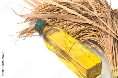 Принти на полотні Rice bran oil in bottle glass with rice paddy on white