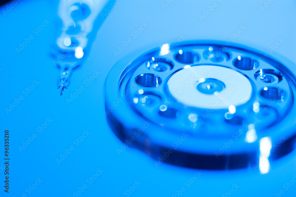 Inside hard drive cylinder and head macro blue color Inside hard drive cylinder and head macro blue color