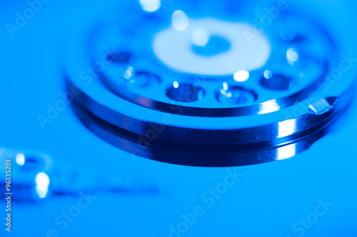 Inside hard drive cylinder and head macro blue color