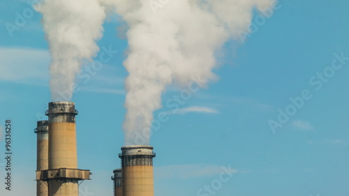 Close up telephoto shot of emissions from electricity power plant generating station chimneys smoke stacks