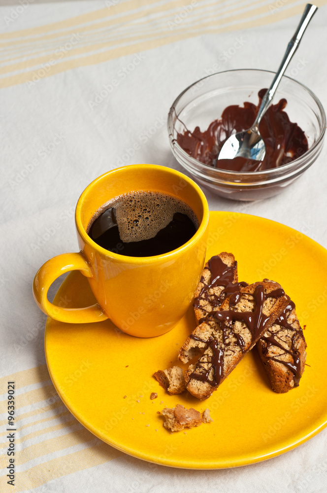 Peanut Butter Oatmeal Biscotti on a yellow plate with cup of espresso, and bowl of chocolate frosting Peanut Butter Oatmeal Biscotti on a yellow plate with cup of espresso, and bowl of chocolate frosting